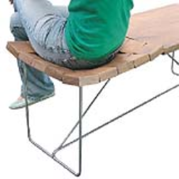 An area of wood tiles connected by elastic provide cushioning on a table