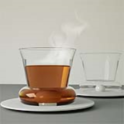 A small ceramic ball in the bottom of a cup can replace a spoon to mix the milk and sugar