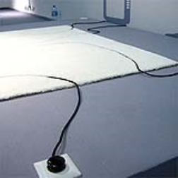 The cable's path is cut into the carpet