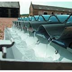 Two corrugated plastic sheets, riveted together, provide the means to heat water using sunlight