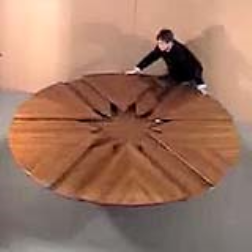 This round table has expansion leaves which make the table bigger when it is rotated