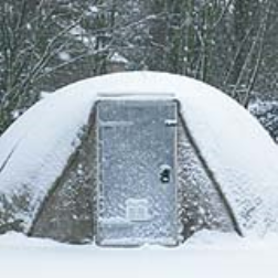 A rapidly deployable hardened shelter that requires only water and air for erection