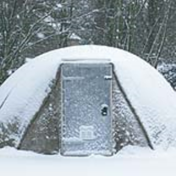 A rapidly deployable hardened shelter that requires only water and air for erection