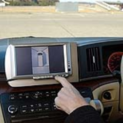 A car dashboard screen which shows a panoromic view of the car