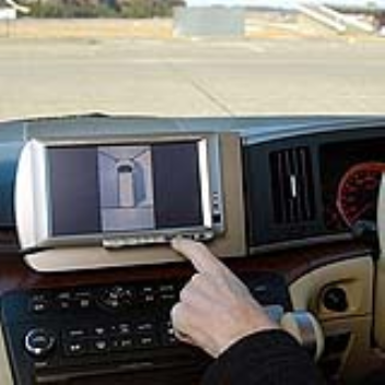 A car dashboard screen which shows a panoromic view of the car
